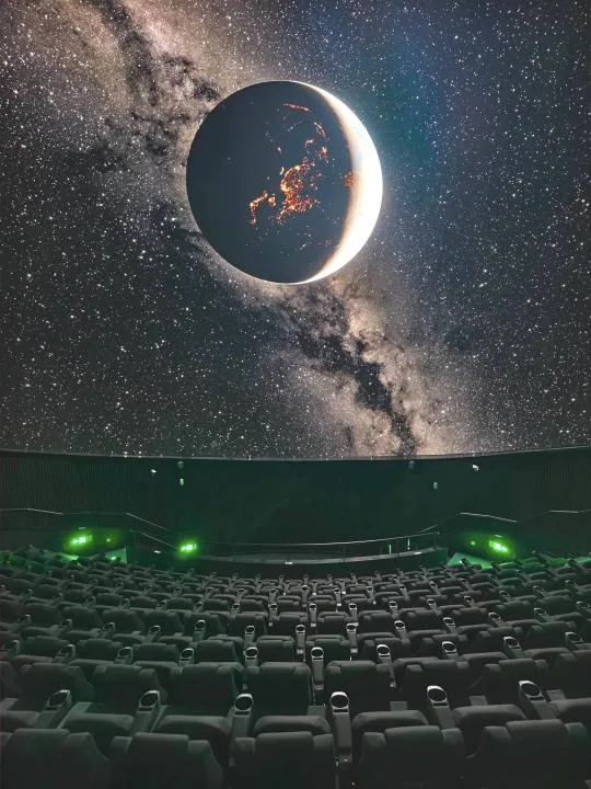 LEDドームに皆既月食の映像が映し出されたプラネタリウムの客席